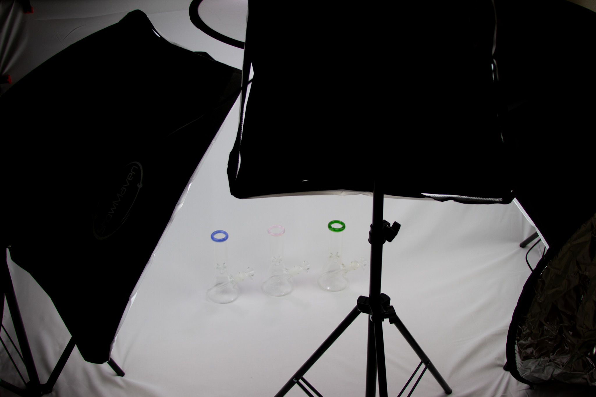DIY home studio — softboxes and a tripod set up around three Flow3r beakers on a white sweep